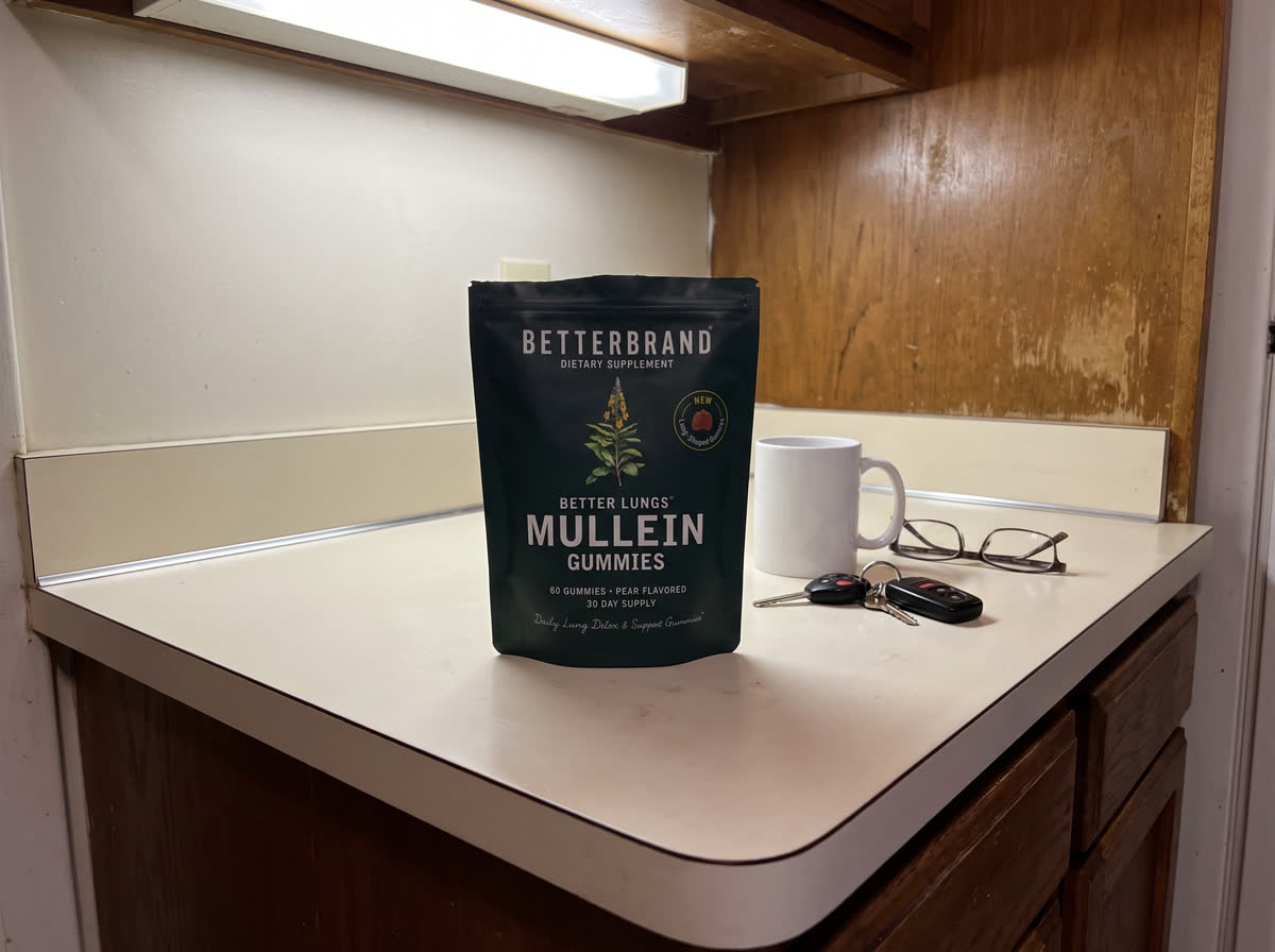 A bag of BetterLungs Mullein Gummies on a clean kitchen counter beside a mug, car keys and reading glasses